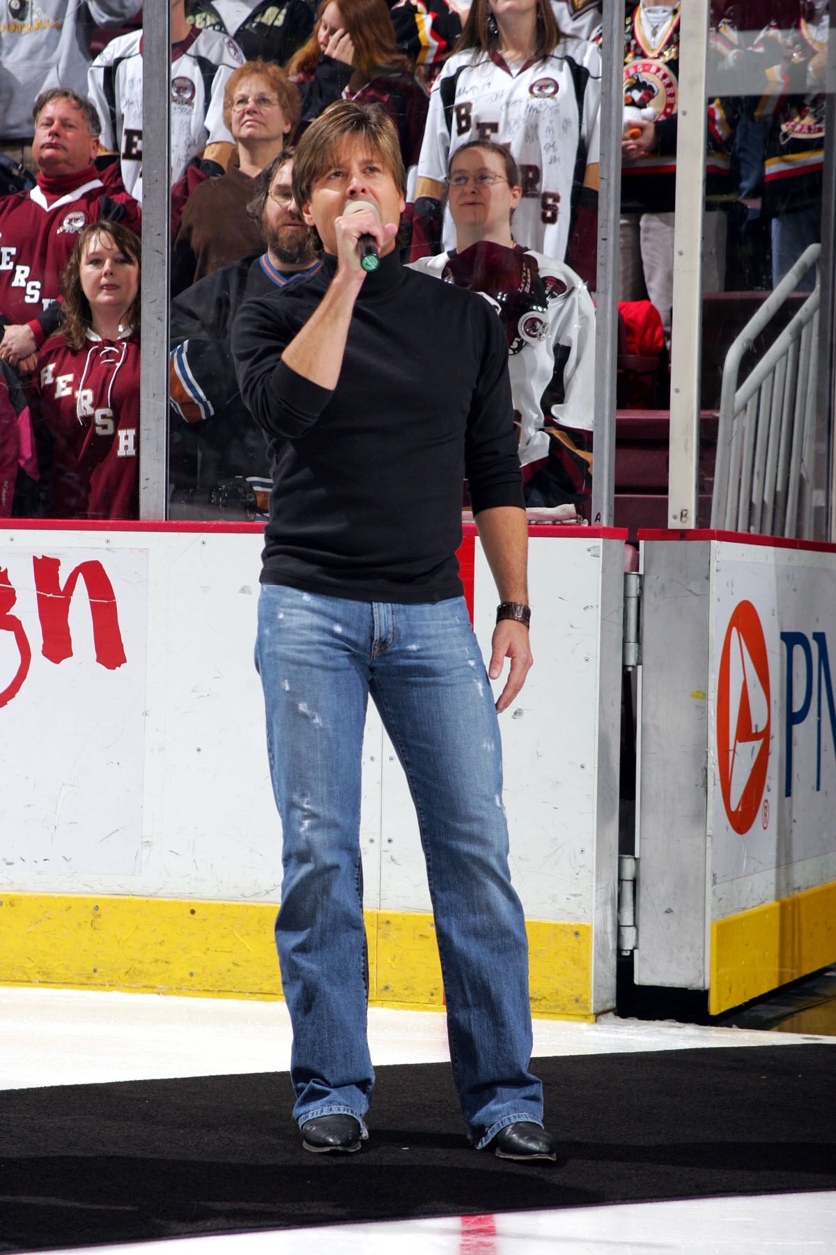 Woody Bradshaw singing the national anthem at a hockey game