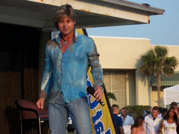 Woody Bradshaw performing on stage in a blue shirt